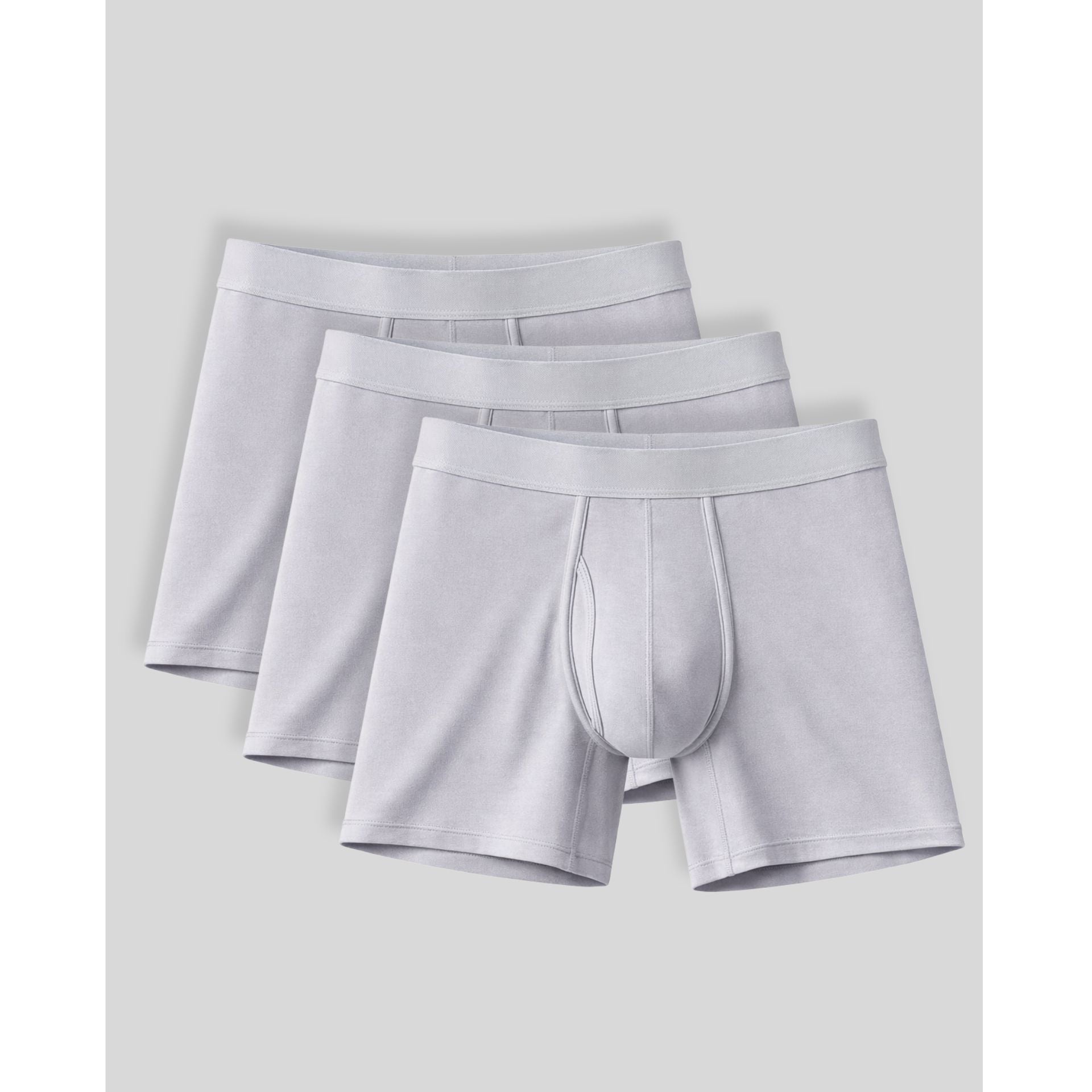 Three pairs of light gray boxer briefs stacked on a light gray background