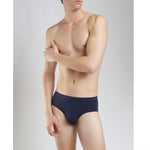 Model wearing SilkCut Micro Modal Air men’s white brief side view showing ergonomic pouch design