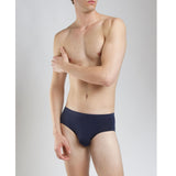 Model wearing SilkCut Micro Modal Air men’s white brief side view showing ergonomic pouch design