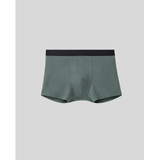 Green boxer briefs with black waistband on a light gray background