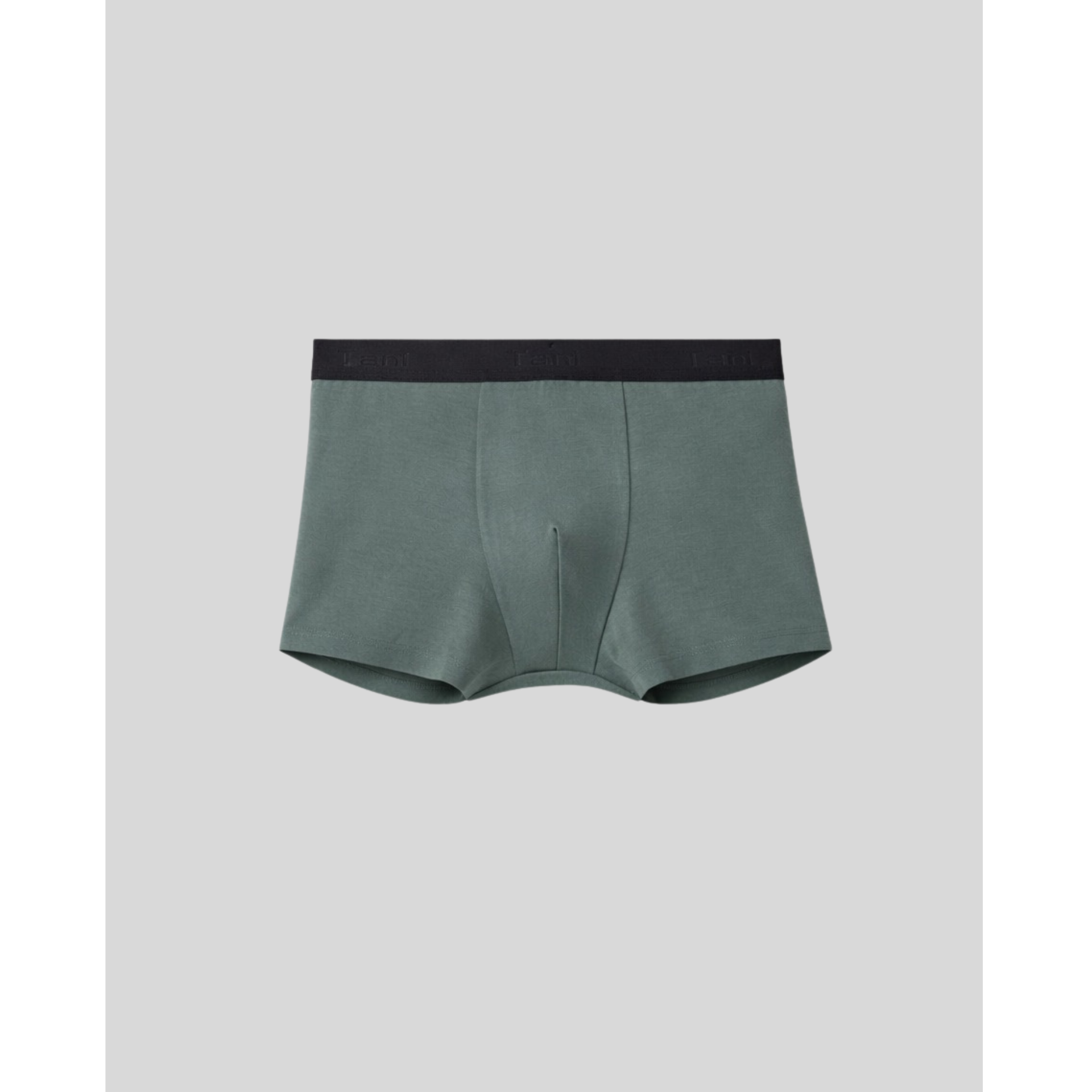 Green boxer briefs with black waistband on a light gray background