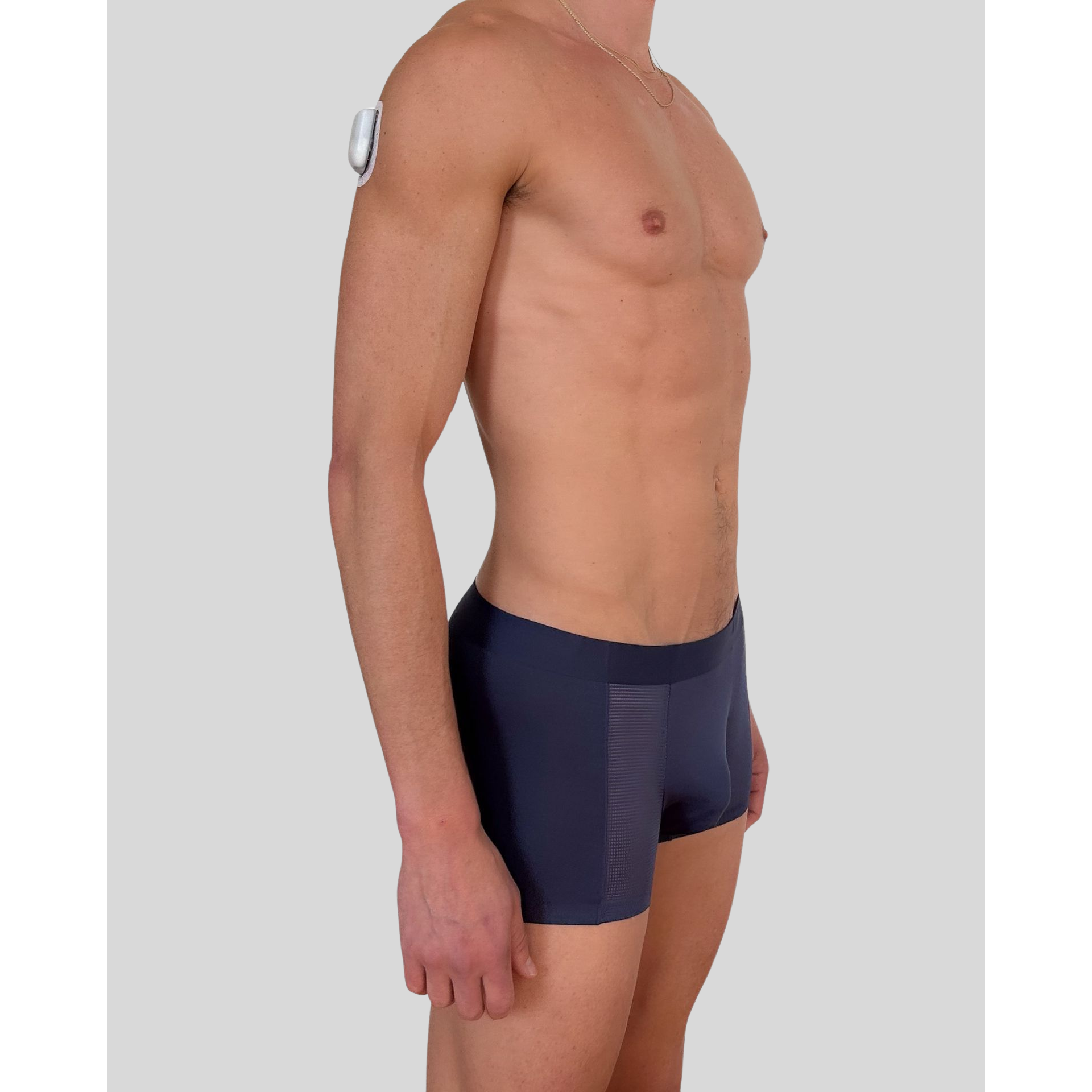 Side view of model wearing SilkCut grey trunks demonstrating stretch fit